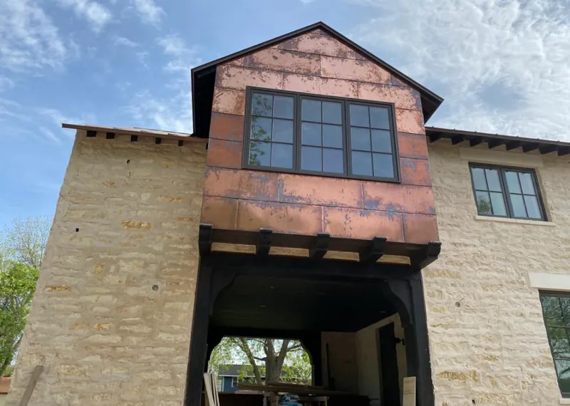 Copper metal panel facade on a stone building for Roof Repair in West Livingston